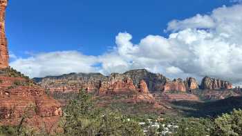 Dramatic clouds drift across Sedona’s sculpted red-rock skyline